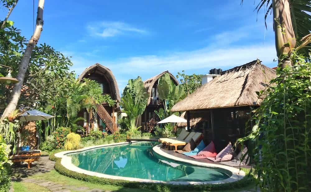 SurfWG grounds, pool and thatched-roof buildings