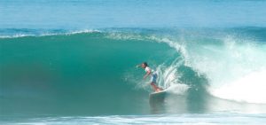 SurfWG Bali Surf camp - a surfer on a right hander wave