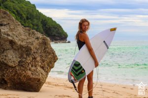 Surf WG Surfcamp Bali Surfergirl and er Board at Beach