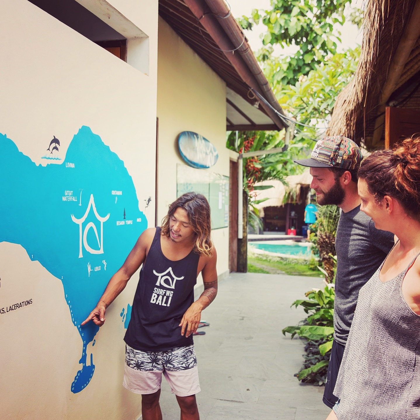 A surf guide showing our SurfWG bali Surf camp plan to guests at our surf school Bali