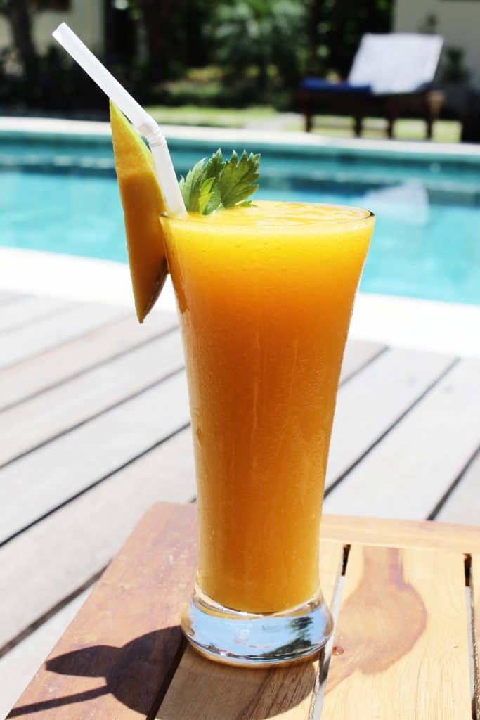 Juice SurfWG surf camp manggo juice on table in front of pool