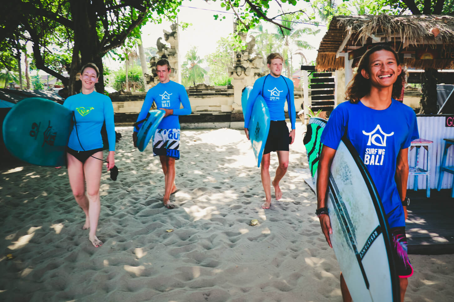 SurfWG Bali surf camp our guides risky and his guest on the beach