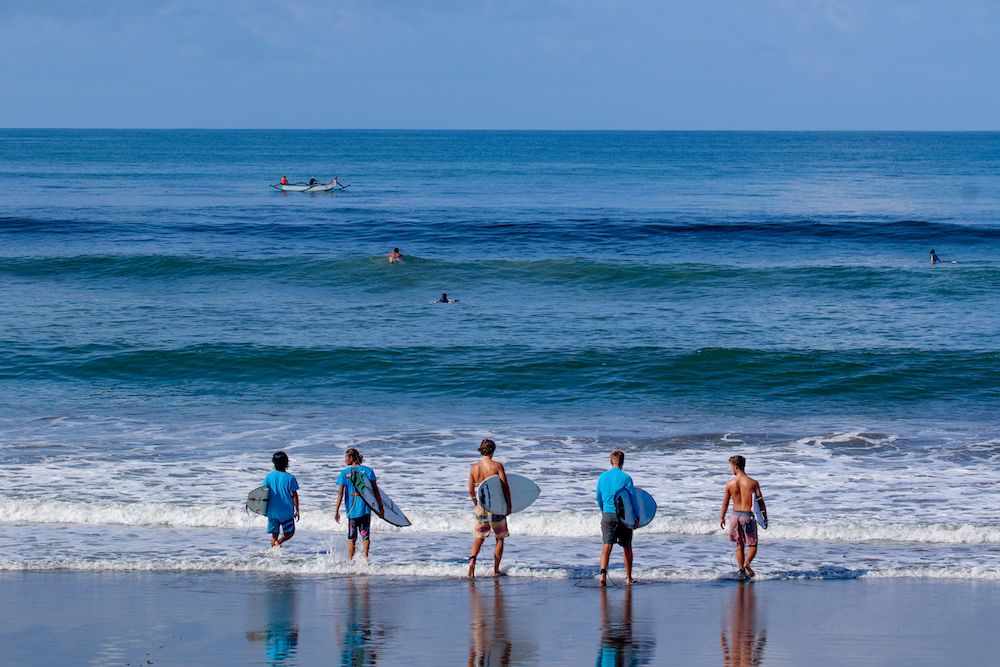 SurfWG Bali surf camp surf guides with guests checking waves